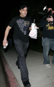 Sam Lutfi old candids with a take-out meal box