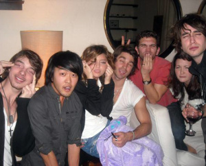 Miley Cyrus and her friends slanting their eyes to look Asian