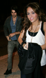 Miley Cyrus and Justin Gaston together at Koi restaurant in Los Angeles California on February 12th 2009