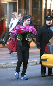 Penn Badgley leaving a midtown Manhattan hotel with flowers on the morning of February 16th 2009