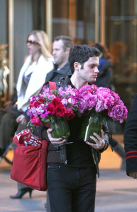 Penn Badgley leaves a midtown Manhattan hotel with flowers on the morning of February 16th 2009