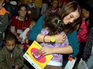 jojo picture happily hugs a child at the Jumpstart Read For The Record event on the 2nd of October 2008