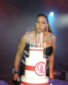 Queen Latifa blows the candles of her huge birthday cake