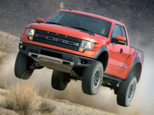 Ford f150 2010 ford f150 svt raptor orange 2010 Ford F 150 SVT Raptor jumping off the ground front and left side view