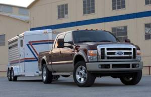 Ford f 250 2009 f 250 brown and champagne 2009 f 250 super duty towing a trailer front and right side view