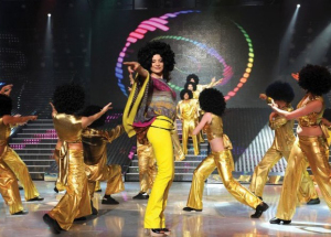 Hilda Khalife in a 70's hair wig dancing on stage with the students at the LBC Star Academy Ninth Prime