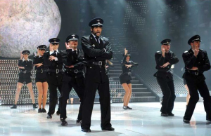 Ibrahim from Kuwait singing onstage with a police outfit on the 10th prime of staracademy season 6 on April 24th 2009