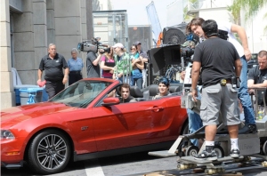 a picture of Kris Allen and Adam Lambert in a red car arriving for the USA Today interview