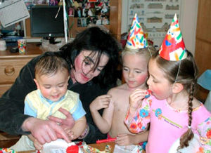 Michael Jackson with his kids at a birthday party