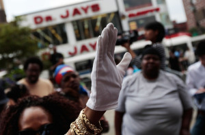 fans singing along to Michael Jackson songs during the live broadcast of his public memorial at the Harlem neighborhood on July 7th 2009 in New York City