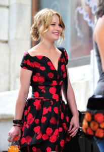 Emilie de Ravin on the filming set of her upcoming movie Remember Me wearing a black and red floral open shoulders dress 2