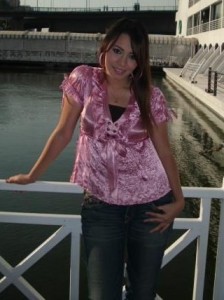 Aya Abdel Raoof picture wearing a pink top over denim blue pants 3