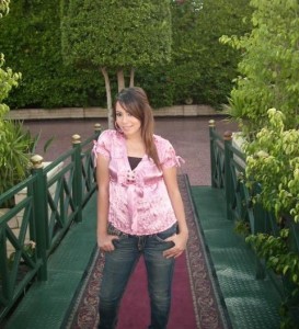 Aya Abdel Raoof picture wearing a pink top over denim blue pants 1