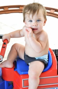 baby Matteo picture as he plays at the beach with his twin baby brother and father Ricky Martin