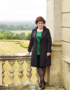 Susan Boyle make over photos in a green top under a long stylish black coat