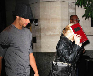 Jesus Luz picture with his girlfriend Madonna as she hides her face with a copy of the book Zohar to avoid the flashes of paparazzis cameras on september 22nd 2009 in New York 1