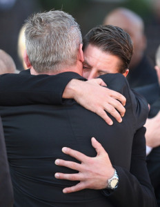 Keith Duffy hugs a member of the family at the funeral of Boyzone singer Stephen Gately at St Laurence O'Toole Church on October 17th 2009 in Dublin Ireland