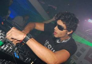 DJ Jesus Luz picture wearing a black tshirt with Jesus Te Ama imprinted on it while playing his music on stage on October 17th 2009 3