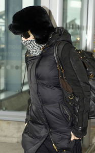 Madonna arrives at Heathrow International Airport in London on January 26th 2010 while covering her face with a checkered scarf 1