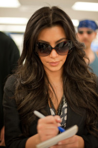 Kim Kardashian spotted arriving in Miami on February 2nd 2010 wearing a black raincoat 9