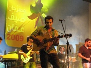 Basel Khoury picture while playing the guitar and performing on stage at a concert 12