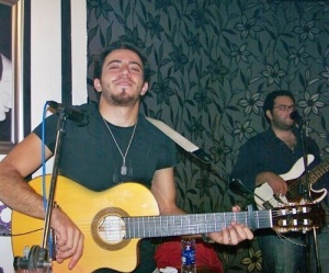 Basel Khoury picture while playing the guitar and performing on stage at a concert 2