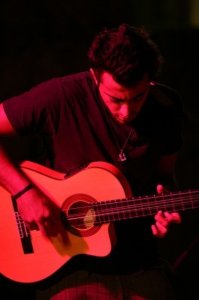 Basel Khoury picture while playing the guitar and performing on stage at a concert 28