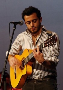 Basel Khoury picture while playing the guitar and performing on stage at a concert 4