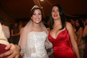 Asmaa Mahalawi at a wedding wearing a red dress