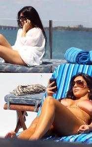 Kim Kardashian and Kourtney Kardashian spotted relaxing and sun bathing on a yakht on March 20th 2010 in Miami Florida 3