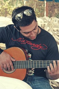 Mohammad Al Qaq playing the guitar