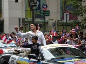 Osvaldo Rios spotted by photographers as he participates at a parade 1