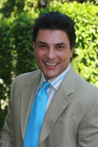 Osvaldo Rios wearing a beige suit