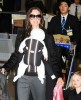 Angelina Jolie carrying baby Vivienne Marcheline and holding Shiloh's hand as they arrive at the Narita International Airport on 27th January 2009