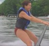 Rachael Ray water surfing in a red swimsuit