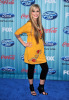 megan corkrey on the blue carpet wearing a yellow top like dress