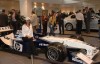 Francesca Lukasik beside a racing car