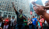 fans dancing to a Michael Jackson songs as the public memorial service is played on street TV screens in Times Square New York City on July 7th 2009