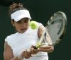 Sania Mirza during a tennis game playing on the field