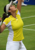 Sania Mirza during a tennis game wearing a yellow tshirt