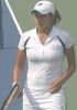 Sania Mirza during a tennis game in a white outfit