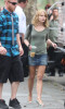 Emilie de Ravin on the filming set of her upcoming movie Remember Me wearing a blue denim skirt under a gray top