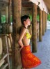 Noriko Sakai poster photos for print wearing an orange skirt and a yellow bra