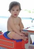 Valentino picture as he plays at the beach with his twin baby brother Matteo and father Ricky Martin