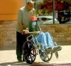 Michael Jackson on a wheel chair wearing a mask