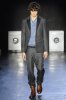 Marlon Teixeira on the runway wearing a blue top under a semi formal dark suit