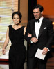 Tina Fey and actor Jon Hamm present the Outstanding Supporting Actress in a Comedy Series award onstage during the 61st Primetime Emmy Awards