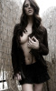 Ashley Greene picture wearing a black coat over a naked chest