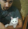 Mohamad Qwaider personal photo with his white small pet cat at his house 2