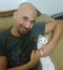 Mohamad Qwaider personal photo with his white small pet cat at his house 4